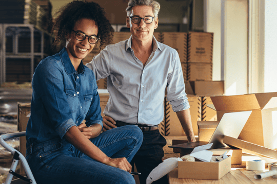 Woman and man in office with boxes