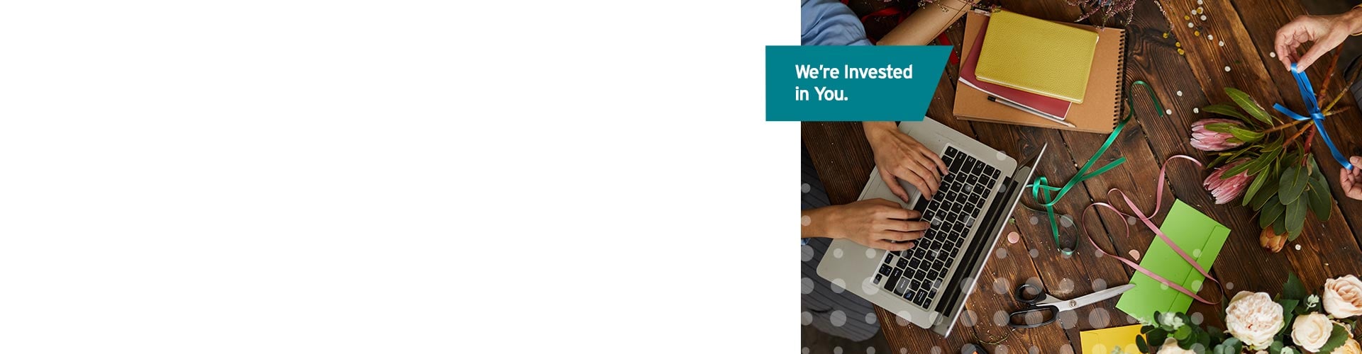 Teal label reads “We’re invested in you,” Photograph of person using laptop with team members conveying support for business collaboration.