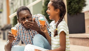 dad and daughter laughing eating ice cream