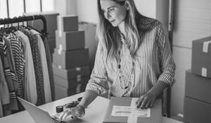 woman small business clothes owner working on laptop