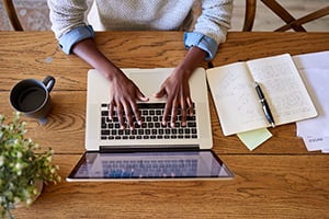 Birdseye view of business person working on a laptop.