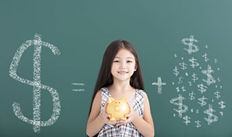 smiling girl with piggy bank