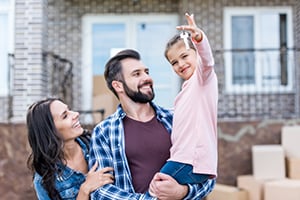 smiling parents with young girl holding keys