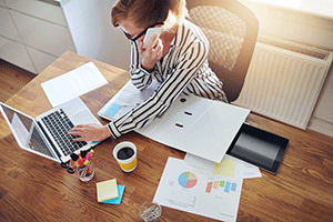 business woman fighting financial scam on computer and phone