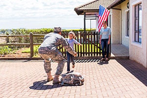 miliary dad meeting child on new home deck