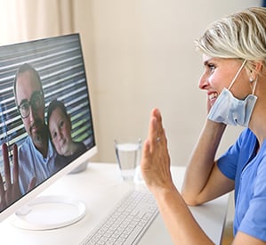 smiling nurse with mask video conferencing family