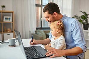 dad with child comparing checking accounts