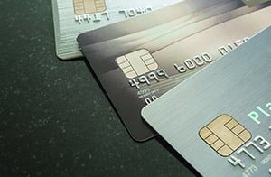 three credit cards spread out on a table