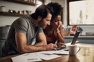 couple reviewing laptop
