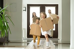 happy family inside with moving boxes