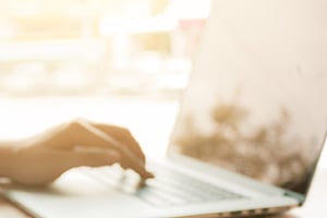 Hand on keyboard representing business financial work