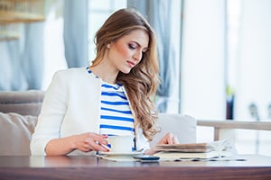 business woman reading a book to enhance business acumen
