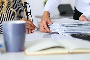 Closeup of employees working on paperwork