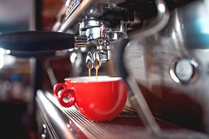 espresso machine with red coffee cups