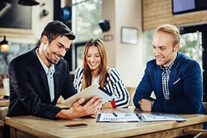 three diverse business people reviewing paperwork