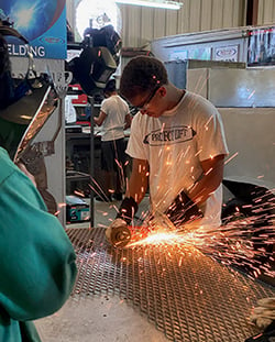 student welding in a shop class