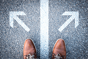 dress shoes on sidewalk with arrows pointing opposite directions
