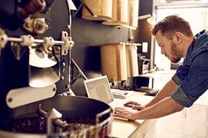 industrial business owner working on computer intently