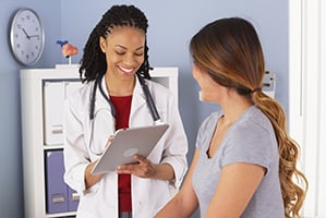 smiling women doctor and patient