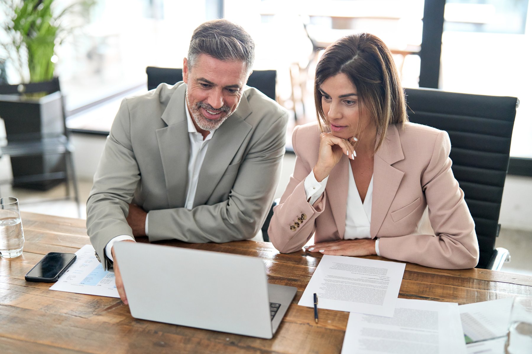 Couple at table looking at laptop
