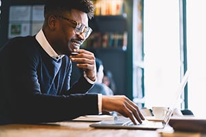 smiling young male attorney on laptop