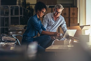 man and woman preparing packages for shipping