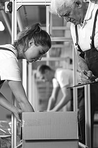 Woman packing a box at a wholesale distribution center