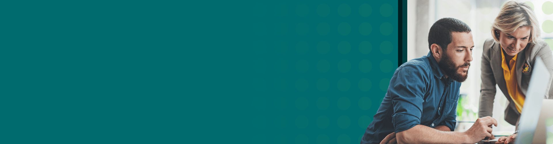 Two coworkers looking at a computer