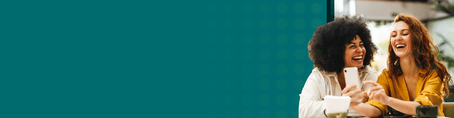 Two friends sitting at a table in a café.