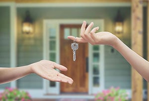 hands taking house keys