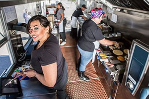 female small business owner working inside a kitchen