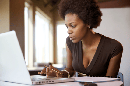 Woman looking up information on a laptop computer