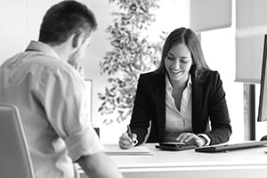 two smiling business professionals in a meeting