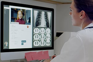 female doctor looking at xrays on computer