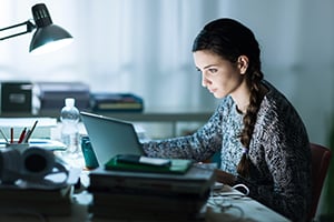 woman working intently on her laptop