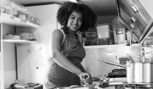 smiling woman working in kitchen