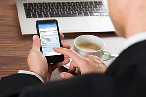 man conducting small business banking on cell phone